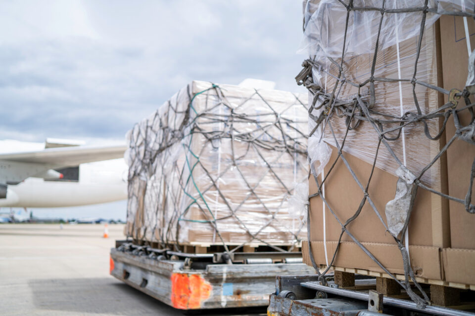 air freight cargo on dolly trailer waiting to be loaded onto air