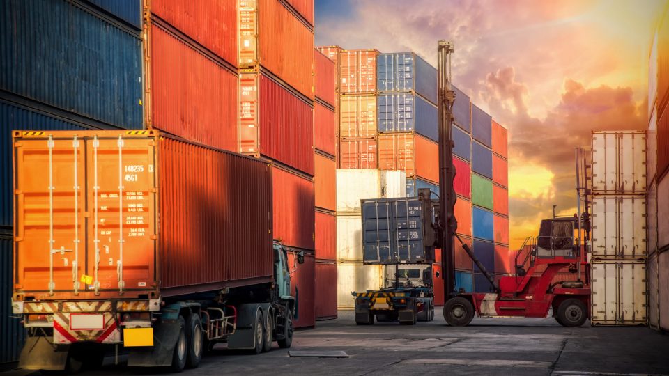 Uppställningsplats och fordon för lastning av containrar för sjöfrakt.